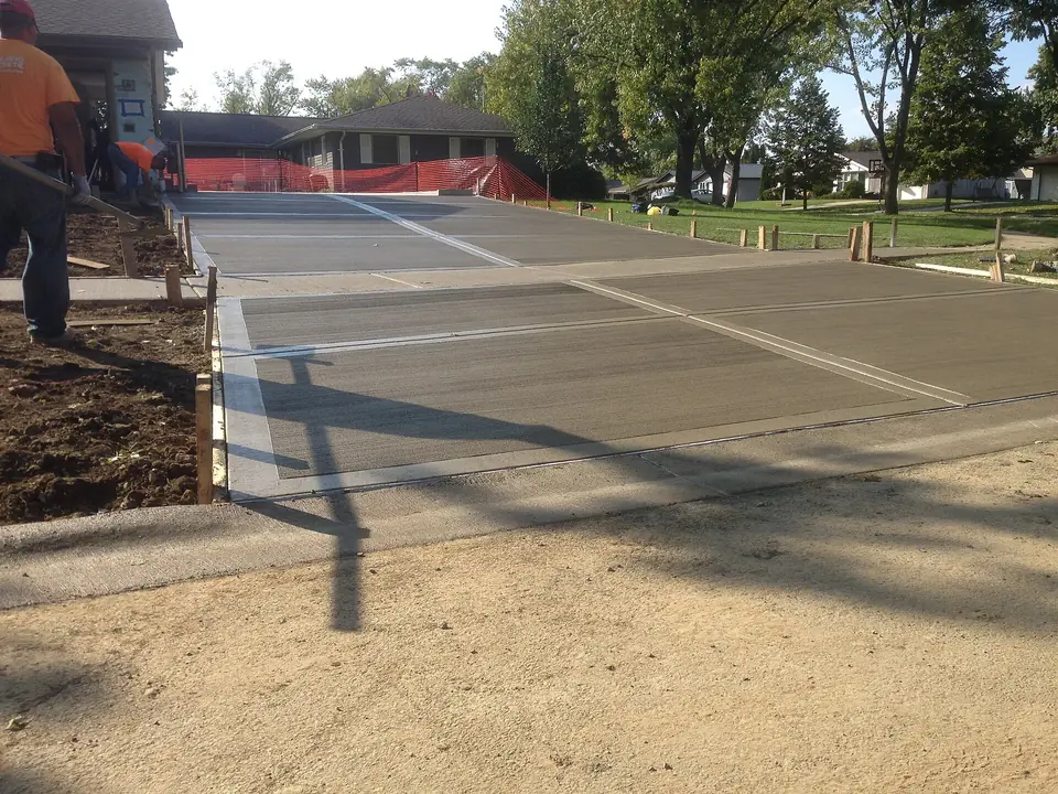 New concrete driveway being poured and finished