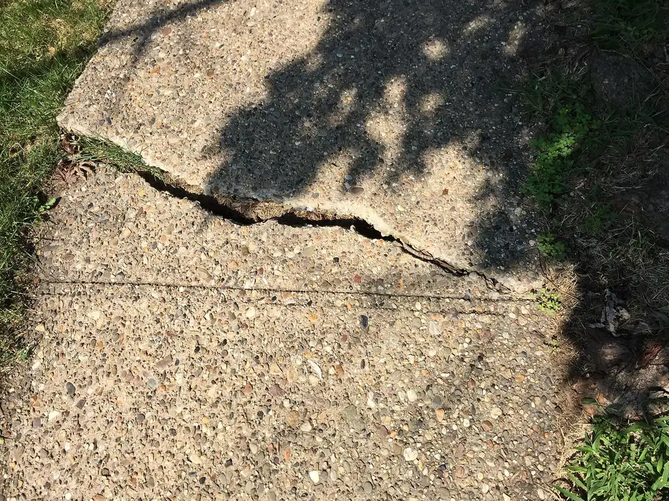 Wide crack running through an old concrete slab