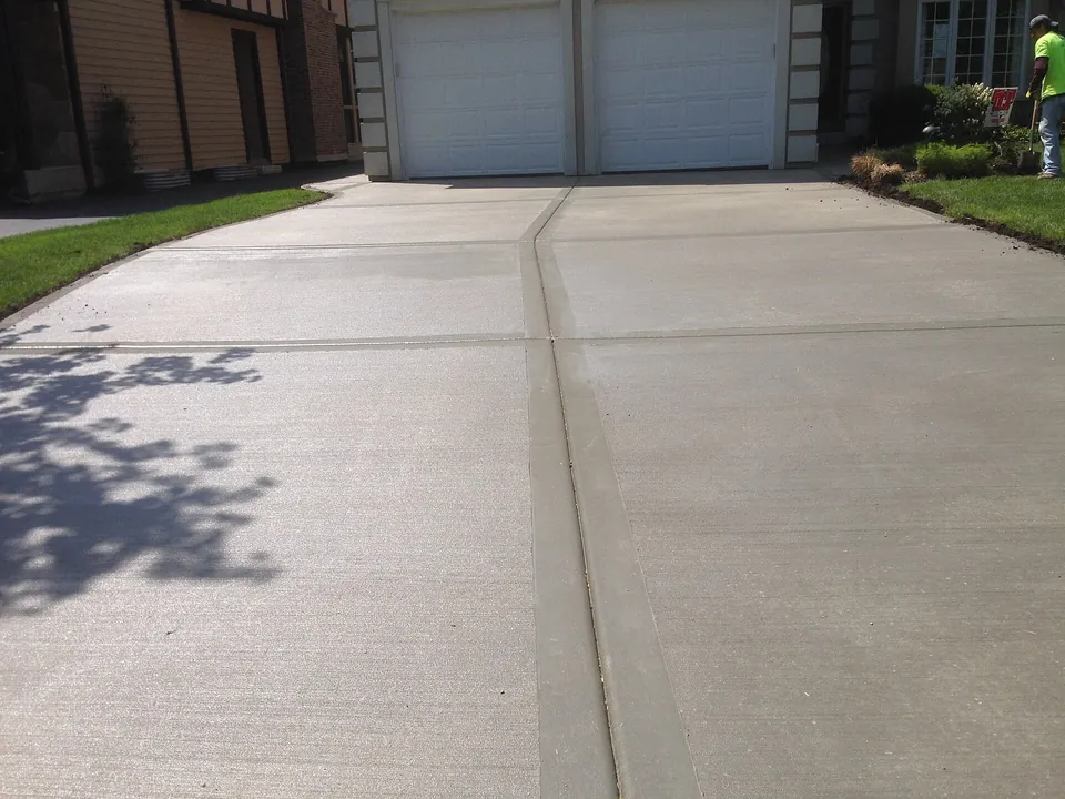 Freshly finished broom-textured concrete driveway