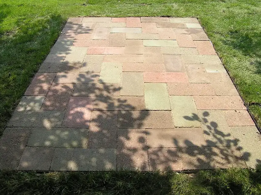 Backyard paver patio set in a grid pattern